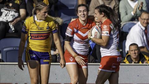 Leeds' Caitlin Beevers looks disappointed as Saints celebrate a try