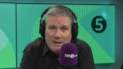 Sir Keir Starmer in front of a green 5Live background.