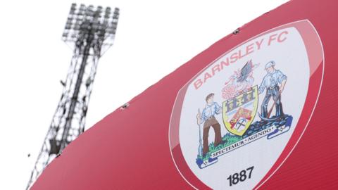 A floodlight and club sign at Oakwell, home of Barnsley FC