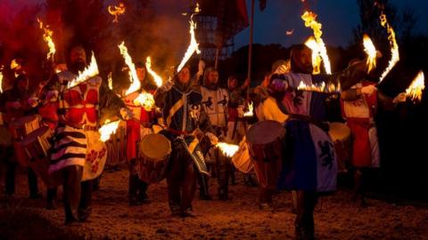 Drummers with flaming drum sticks