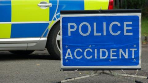 A police sign and car