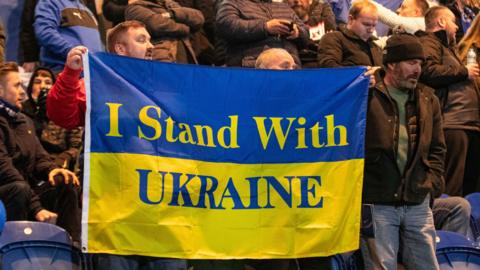 Colchester fans holding Ukraine supporting banner