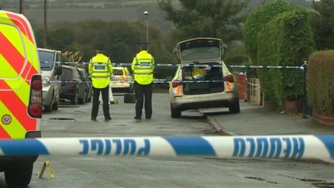 Police at the scene in Llay