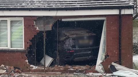 Car smashes into front of house