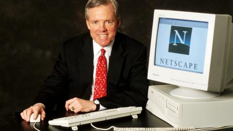 James Barksdale with a computer showing the Netscape logo