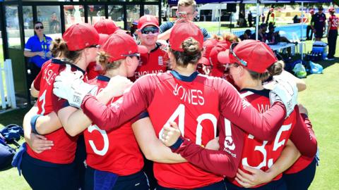 England in a huddle before taking the field