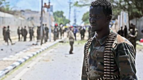 A Somalian soldier at the scene of a suicide car bomb blast in Mogadishu on August 30, 2016