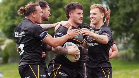 Cornwall players celebrate a try