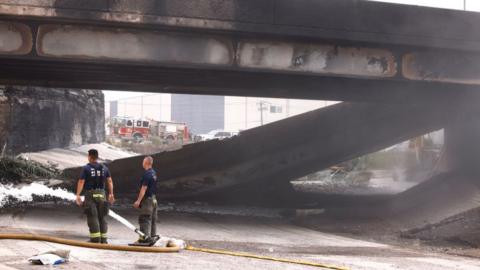 Officials at the site of the highway collapse