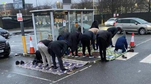 Drivers praying at bus stop