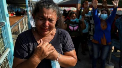 People pray outside the Penitenciaria del Litoral prison