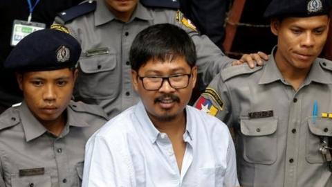 Detained Reuters journalist Wa Lone is escorted by police while leaving Insein court in Yangon, Myanmar July 9, 2018.