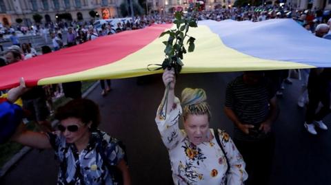 Protesters chant "resign" at a rally in Romania over missing teen Alexandra Macesanu