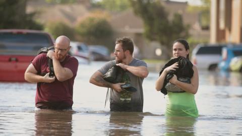 Houston residents try to keep dry after leaving their homes