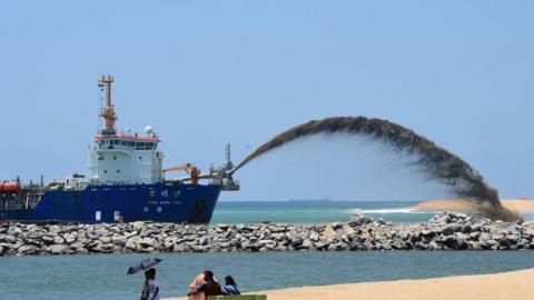 A dredger pumps sand to reclaim land just outside the port of Colombo in Sri Lanka in 2017