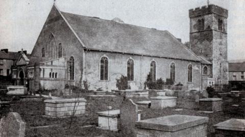 Old photo of St Mary's showing graves in the foreground