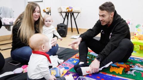 Doncaster's Tommy Rowe (right) takes on childminding duties