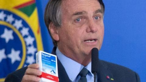 President of Brazil Jair Bolsonaro shows a box of chloroquine medicine on 16 September 2020