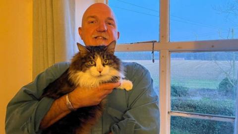 Eric Wareham with his cat