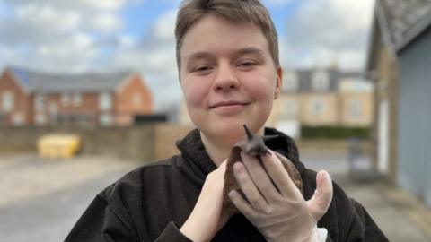 Connor Bouttell with one of his snails