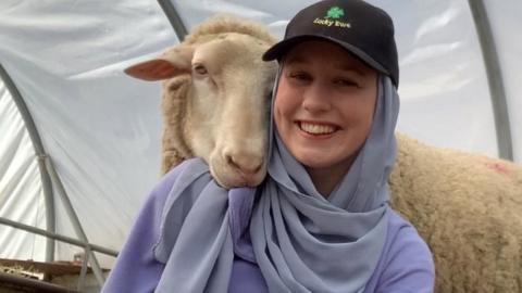 Abby-Leigh with a sheep over her shoulder