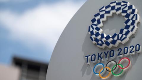 A sign with the logo of the Tokyo 2020 Olympics