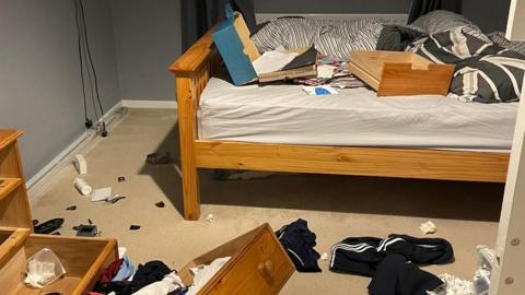 Mr Lawrence's bedroom which was ransacked by thieves with draws pulled out