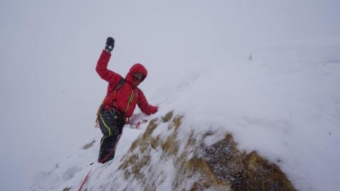 Tom Livingstone on top of the mountain