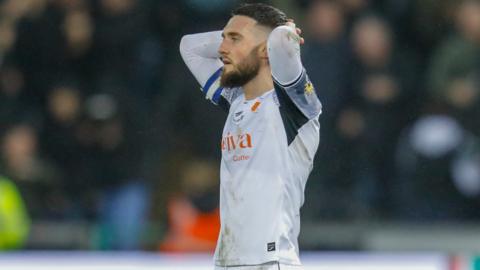 Matt Grimes looks dejected after Swansea's defeat to Plymouth