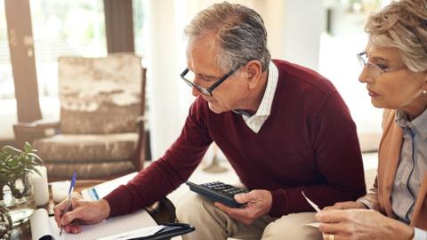 Couple looking at notepad