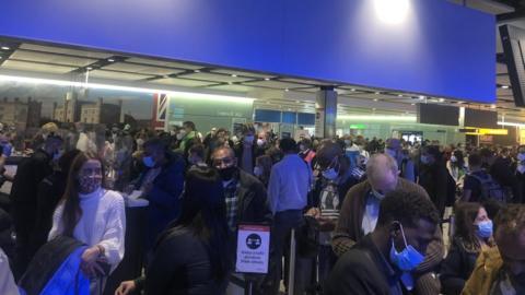 Large queue of travellers at Heathrow Airport