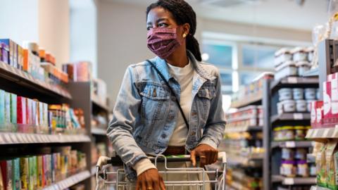 A woman shopping in a mask