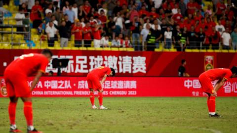 Chinese players react with disappointment after losing 1-0 to Syria