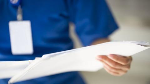 image of a nurse with paperwork