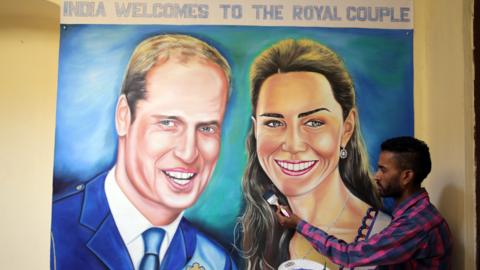 Artist Jagjot Singh Rubal puts the finishing touches to a painting of the Duke and Duchess of Cambridge at his studio in Amritsar