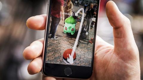 A close-up view of a gamer playing Pokemon Go at Grote Markt in Haarlem, Holland