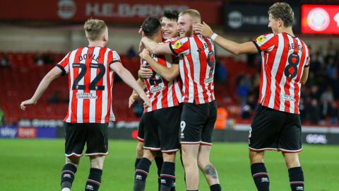 Sheffield United players celebrate a goal against Reading