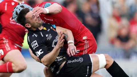 Scarlets v Dragons: Jonathan Davies tackles Josh Lewis