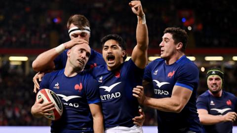 Maxime Lucu of France celebrates with teammates after scoring his team's fifth try during the Guinness Six Nations 2024 match between Wales and France