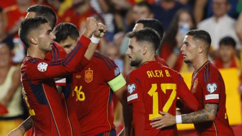 Spain players celebrate together after a goal