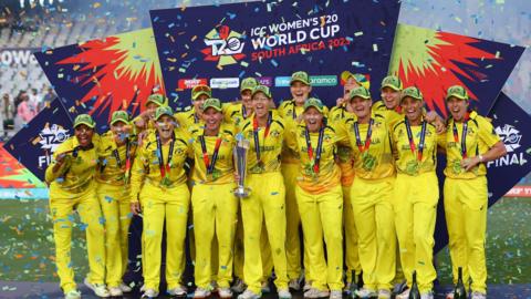 Australia celebrate with the trophy after winning the Women's T20 World Cup