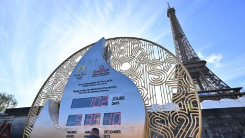 The Eiffel Tower with a giant clock counting down to the Paris Olympics