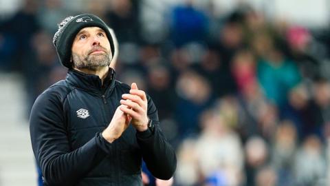 Derby County boss Paul Warne looks skyward