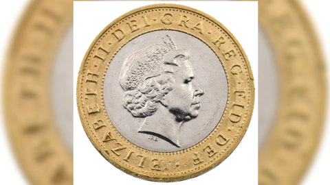 The heads side of the coin, showing the image of the late Queen Elizabeth II with text round the edge which misses out the words two pounds