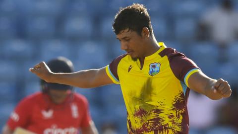 Gudakesh Motie (R) of West Indies celebrates the dismissal of Liam Livingstone