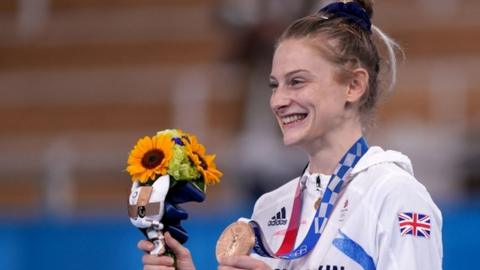 Bryony Page smiles after being presented with her bronze medal from the women's trampolining final at the Tokyo Olympics