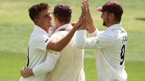 Tom Lawes takes a wicket for Surrey