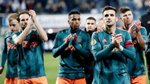 Ajax players applaud the fans