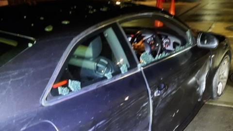 Black Audi car with smashed driver's window