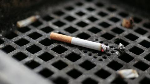 A cigarette on a grate